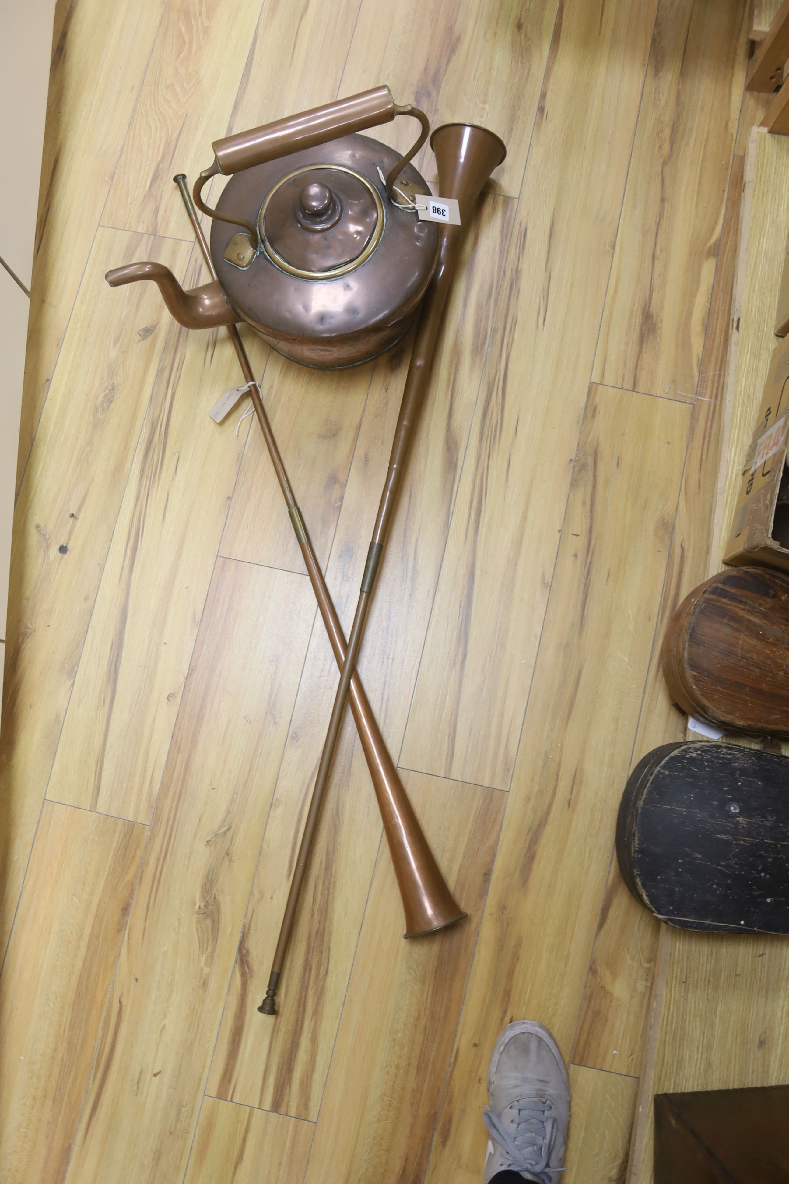 A large Victorian copper kettle with cover, 43cm including handle, and two copper hunting horns